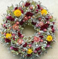 a wreath made out of dried flowers on a table