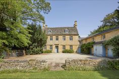 an image of a house that is in the middle of some trees and grass area