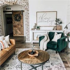 a living room with two couches and a coffee table in front of a brick wall