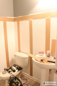 a bathroom that has been stripped and is in the process of remodeling