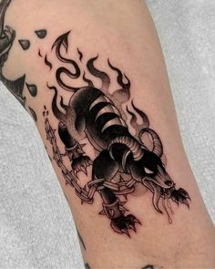 a black and white tattoo on the leg of a man with a rat crawling through it