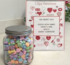 a jar filled with conversation hearts next to a valentine's day card