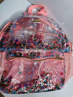 Let sparkles take your style to the next level with this fun and fashionable give me all the glitter backpack! It's the perfect way to stow your essentials in a sleek, spacious way that's sure to turn heads. Whether you're jetting off for a weekend getaway or making a statement on campus, this trendsetting bag is sure to keep you shining bright. Be the star of your own show with this bag! NOT available for in store credit or exchange(see policy for more info) filter used to brighten color School Glitter Backpack, School Backpack With Glitter Details, School Backpack With Glitter, Glitter Backpack, Top Graphic Tees, Swim Accessories, Weekend Getaway, Shoe Collection, Next Level