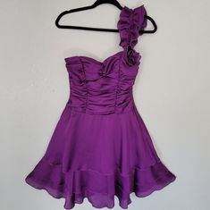 A Purple One Shoulder Ruffle Dress With Ruched Top And Flowy Tier Bottom. One Shoulder Is On The Left Side. Small Flower On One Shoulder. Very Flowy, Great For Salsa Dancers, Dancing, Wedding Guest, Or A Night Out. In Size 3 Which Fits Like An Xs. New Without Tags. Open To Offers. One Shoulder Ruffle Dress, Dancing Wedding, Salsa Dancer, Shoulder Ruffle Dress, Ruched Top, Flowy Dress, Sewing Techniques, Purple Dress, Dress First