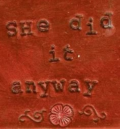 a red sign with the words she did it always go written in cursive writing