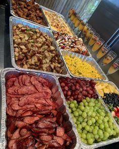 an assortment of food is displayed in trays