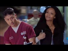 a man and woman in scrubs standing next to each other