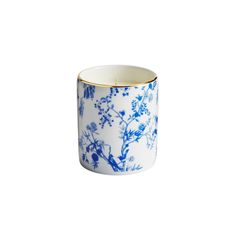 a blue and white cup with flowers on it