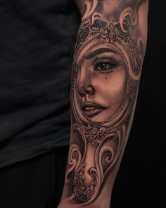 a woman's face in a mirror tattoo on the arm