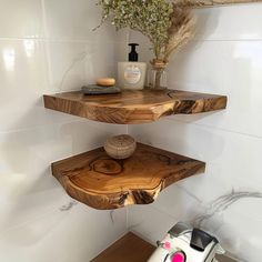 two floating shelves in the corner of a bathroom