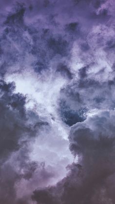 an airplane is flying in the cloudy sky