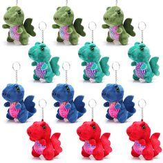 a bunch of stuffed animals that are in different colors and sizes, with key chains attached to them