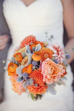 a bride holding a bouquet of flowers in her hand