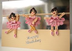 three little figurines are hanging from a clothes line with happy birthday written on it