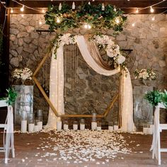 a wedding ceremony setup with flowers and candles