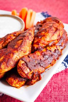 some chicken wings and carrots on a plate