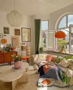 a living room filled with furniture and lots of windows