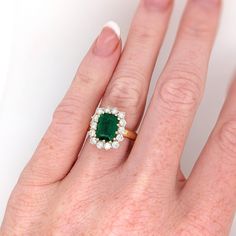 This beautiful ring features a 2.79 carat Emerald gemstone with a halo of natural earth mined diamonds set in solid 18K gold. This Emerald ring makes a lovely May birthstone gift for your loved ones! This ring is made with solid 18K Gold and natural Earth mined SI / G-H diamonds. As listed, this ring is ready to ship. If you're interested in purchasing this setting with a different center stone please message us! Designer Silver Jewellery, Jewelry Showcases, May Birthstone, Birthstone Gifts, Emerald Gemstone, Natural Earth, Beautiful Ring, Earring Findings, Pendant Bracelet