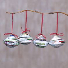 three christmas ornaments hanging from a tree branch