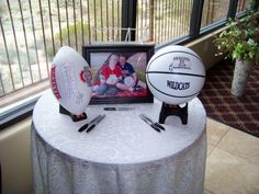 two basketballs are sitting on top of a table with a photo and pen next to it