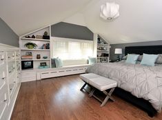 a bedroom with a large bed and built in bookshelves