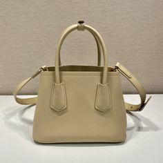 SHOP MORE LUXURY PRODUCTS HERE Description Prada Double Saffiano Mini Bag Beige For Women, Women’s Bags 9.8in/25cm 1BG443_2A4A_F0036_V_XOO Sophisticated, subtle details bring new life to the brand’s iconic designs like the Prada Double bag with its new versatile and sophisticated mini design. Iconic metallic lettering adorns the front, while a removable shoulder strap allows the bag to be worn over the shoulder or as a crossbody bag. Size: 25 x 18.5 x 12.5 cm /9.8 x 7.3 x 4.9 inches Beige Epsom Leather Bag For Evening, Beige Epsom Leather Evening Bag, Beige Epsom Leather Bag With Smooth Grain, Luxury Beige Saffiano Leather Shoulder Bag, Beige Rectangular Epsom Leather Shoulder Bag, Formal Beige Saffiano Leather Bag, Saffiano Leather Crossbody Shopping Bag, Saffiano Leather Crossbody Bag For Shopping, Designer Beige Saffiano Leather Shoulder Bag