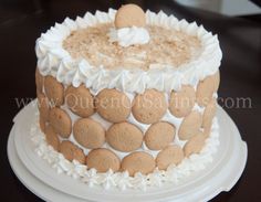 the cake is decorated with white icing and brown cookies on it's side