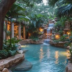 an outdoor swimming pool with waterfall surrounded by greenery and lights on the ceiling is lit up at night