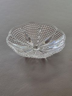 a clear glass bowl sitting on top of a table