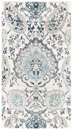 a blue and white rug with an ornate design on the bottom, in various colors