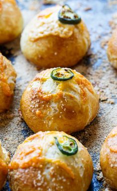 several baked goods on a baking sheet ready to be cooked in the oven or used as an appetizer