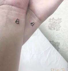 two people with matching tattoos on their arms