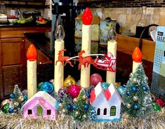 a table topped with candles and christmas decorations