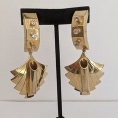 Cool and Edgy Futuristic Style Vintage Drop Earrings. Unique design, they are brutalist and large yet light on the ear.  Goldtone two individual metal parts, connected with a link.  Four Clear Color Crystals on the top side, a   goldtone tune on the lower part. Have some sign of patina on the back. All jewellery may have light scratches due to age. Thank you for looking and if you have any questions please don't hesitate to ask :) Retro Metal Earrings For Evening, Art Deco Metal Earrings For Evening, Vintage Drop Earrings, Earrings Art Deco, Futuristic Style, Earrings Art, Art Deco Earrings, Earrings Unique, Art Deco Style