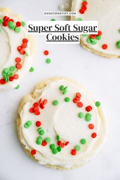 three sugar cookies with white frosting and sprinkles