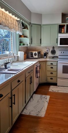 a kitchen with wooden floors and green cabinets