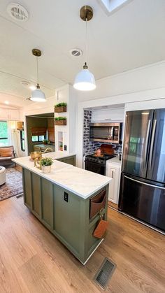 a kitchen with an island, stove and refrigerator