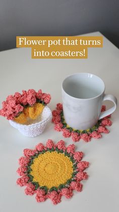 two crocheted coasters and a coffee cup on a white table with pink flowers