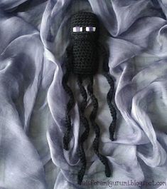 a crocheted doll laying on top of a blanket