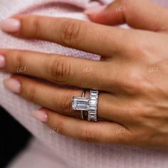 a woman's hand with a diamond ring on it