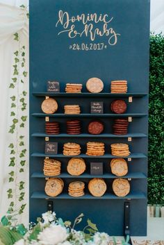 a table topped with cookies and crackers next to a sign that says romantic & muffins