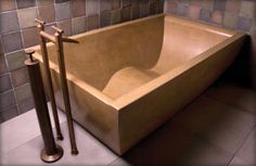 a bathtub in a tiled bathroom next to two metal poles and a toilet paper dispenser