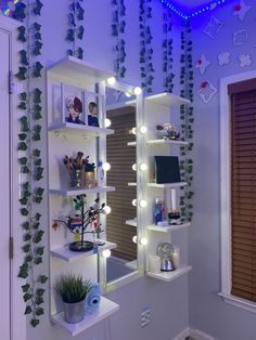 a white shelf filled with lots of plants next to a window