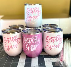 four pink and white tumbles with the words birthday squad on them sitting on a table