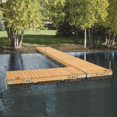 a wooden dock sitting in the middle of a lake