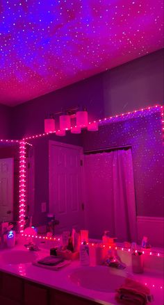 the bathroom is decorated with purple lights and stars on the ceiling, along with other decorations