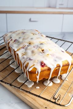 a cake with icing sitting on top of a cooling rack