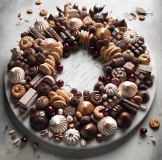 a white plate topped with lots of different types of chocolates and nuts on top of it