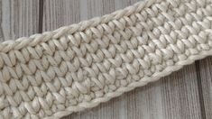 a close up view of the side of a white knitted headband