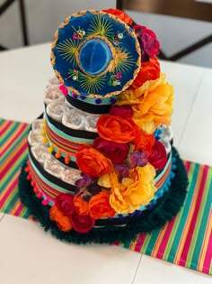 a multi - tiered cake decorated with colorful flowers